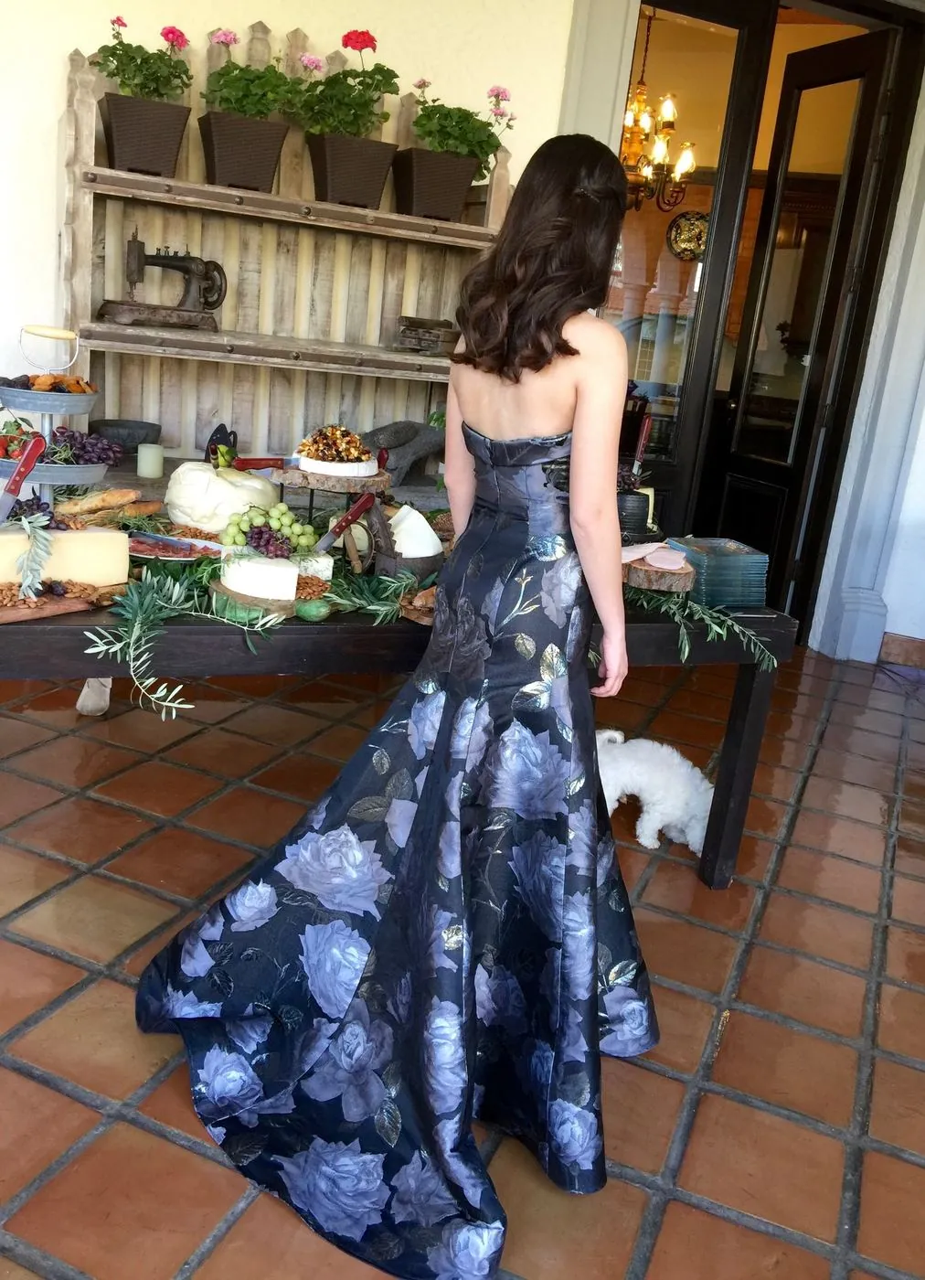 Navy floral gown with a fitted bodice and a trained skirt, seen from behind.